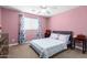 Bright bedroom with a gray platform bed, large window, and traditional furnishings at 15856 N 76Th Ave, Peoria, AZ 85382