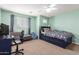 bedroom with blue and green color palette and a built-in bookcase, and a sofa at 15856 N 76Th Ave, Peoria, AZ 85382