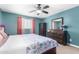 Well-lit bedroom features a ceiling fan, dresser, and window, providing ample natural light at 15856 N 76Th Ave, Peoria, AZ 85382