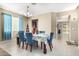 Inviting dining room featuring a table set for six with blue chairs, natural light, and tile flooring throughout at 15856 N 76Th Ave, Peoria, AZ 85382