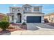 Charming two-story home with a stylish two-car garage, a landscaped yard, and a welcoming front entrance at 15856 N 76Th Ave, Peoria, AZ 85382