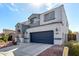 This two-story home has desert landscaping, a two-car garage, and a covered entrance at 15856 N 76Th Ave, Peoria, AZ 85382