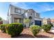 The inviting two-story home features a well-manicured front yard and a two-car garage at 15856 N 76Th Ave, Peoria, AZ 85382