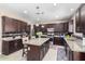 Spacious kitchen with island, stainless steel appliances, and dark wood cabinetry at 15856 N 76Th Ave, Peoria, AZ 85382