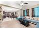 Open-concept living room with modern furnishings flowing into the kitchen and dining area at 15856 N 76Th Ave, Peoria, AZ 85382
