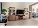 Cozy living room features modern entertainment center, neutral wall color, and carpeted floors throughout at 15856 N 76Th Ave, Peoria, AZ 85382
