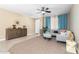 Inviting living room with carpet flooring, a ceiling fan, and a comfortable sectional sofa, perfect for relaxation at 15856 N 76Th Ave, Peoria, AZ 85382