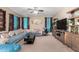 Spacious living room featuring a large sectional sofa, tile and carpet floors, and stylish window coverings at 15856 N 76Th Ave, Peoria, AZ 85382