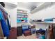 Organized walk-in closet with shelving for ample storage, suitcases and clothing at 15856 N 76Th Ave, Peoria, AZ 85382