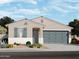 Charming single-story home featuring a well-manicured front yard with desert landscaping and a two-car garage at 15987 W Cottontail Ln, Surprise, AZ 85387