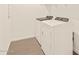 This laundry room has a modern washer and dryer with ample shelving space at 15989 W Cottontail Ln, Surprise, AZ 85387