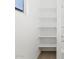 Shower with open shelving, providing practical and stylish storage solutions at 16076 W Prickly Pear Trl, Surprise, AZ 85387