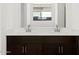 Bathroom featuring dual sinks, cabinets, and a large mirror at 16076 W Prickly Pear Trl, Surprise, AZ 85387