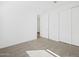 Carpeted bedroom featuring neutral tones, natural light, and a closet at 16076 W Prickly Pear Trl, Surprise, AZ 85387