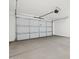 Spacious garage with an automatic door opener and concrete floors at 16076 W Prickly Pear Trl, Surprise, AZ 85387