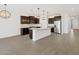 Bright kitchen with island, stainless steel appliances, and wood-look tile floor at 16076 W Prickly Pear Trl, Surprise, AZ 85387