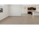 Bright, open-concept kitchen and living space featuring wood-look tile flooring, dark cabinets, and pendant lighting at 16076 W Prickly Pear Trl, Surprise, AZ 85387