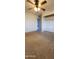 This bedroom features neutral carpet, a ceiling fan and a walk-in closet for easy organization at 1706 W Village Way, Tempe, AZ 85282
