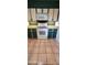 Kitchen featuring modern appliances, white cabinets, and neutral countertops at 1706 W Village Way, Tempe, AZ 85282