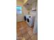 Practical laundry area featuring modern washer and dryer units with tile flooring and a convenient exterior door at 1706 W Village Way, Tempe, AZ 85282