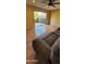 Living room highlighting sliding glass doors to outdoor patio, ceiling fan, and ceramic tile floors at 1706 W Village Way, Tempe, AZ 85282