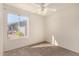 This bedroom has neutral walls, carpeted floor, and a large window at 1716 N Temple St, Mesa, AZ 85203