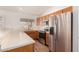 Well lit kitchen with stainless steel appliances, oak cabinets, and bright countertops at 1716 N Temple St, Mesa, AZ 85203