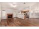 Open concept living room featuring a fireplace, access to the kitchen, and hard wood floors at 1716 N Temple St, Mesa, AZ 85203