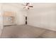 Bright living room with neutral carpet, a ceiling fan, and natural light from a doorway and entry way at 1716 N Temple St, Mesa, AZ 85203