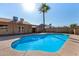 Inviting backyard pool with a mature palm tree and ample patio space for relaxing and entertaining at 1716 N Temple St, Mesa, AZ 85203