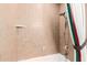 Tiled bathroom with shower and tub, including a showerhead, soap dish, and towel rack for convenience at 1934 E Hale St, Mesa, AZ 85203