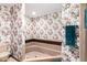 Bathroom with a floral wallpaper, bathtub and a separate water closet at 1934 E Hale St, Mesa, AZ 85203