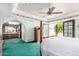 A well-lit bedroom with floral ceiling, vintage furniture, and a connection to a private bathroom at 1934 E Hale St, Mesa, AZ 85203