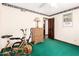 This bedroom has an exercise bike, a small wooden dresser with space for decorations and personal touches at 1934 E Hale St, Mesa, AZ 85203