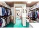 Walk-in closet with hardwood ceiling, built-in shelving, rods for clothing, and green carpet at 1934 E Hale St, Mesa, AZ 85203