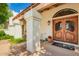 Welcoming entryway with a custom wood door, decorative sidelights, and a cozy covered porch area at 1934 E Hale St, Mesa, AZ 85203