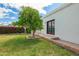 Beautifully landscaped backyard with a mature citrus tree and flowering bushes by the building at 1934 E Hale St, Mesa, AZ 85203