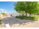 Spacious two-car garage with a basketball hoop, mature shade trees, and a well-maintained lawn on a sunny day at 1934 E Hale St, Mesa, AZ 85203