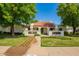 Charming single-story home featuring a red tile roof, lush landscaping, and mature shade trees in a well-maintained front yard at 1934 E Hale St, Mesa, AZ 85203