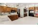 Spacious kitchen featuring wood cabinets, integrated appliances, and ample counter space at 1934 E Hale St, Mesa, AZ 85203