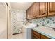 Laundry room with built in storage and white appliances at 1934 E Hale St, Mesa, AZ 85203