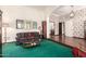 Cozy living room with hardwood floors, floral wallpaper, vintage furniture, and bright natural light from large windows at 1934 E Hale St, Mesa, AZ 85203