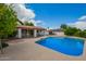 Stunning backyard pool with a covered patio and lush landscaping, perfect for outdoor entertaining and relaxation at 1934 E Hale St, Mesa, AZ 85203