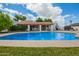 Large swimming pool with a covered patio, offering an ideal space for outdoor relaxation and entertainment at 1934 E Hale St, Mesa, AZ 85203