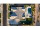 Luxury home featuring a swimming pool, lush landscaping, and a spacious roof, captured from above at 19901 E Country Meadows Dr, Queen Creek, AZ 85142