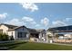 Expansive backyard with green grass, fire pit and covered outdoor seating area at 19901 E Country Meadows Dr, Queen Creek, AZ 85142