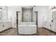 Luxurious bathroom featuring a soaking tub, dual vanities, and a walk-in shower at 19901 E Country Meadows Dr, Queen Creek, AZ 85142