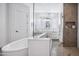 Bright bathroom featuring an oval soaking tub, walk-in shower with neutral tile, and white cabinets at 19901 E Country Meadows Dr, Queen Creek, AZ 85142