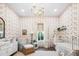 Charming Bedroom with floral wallpaper, white crib, patterned rug, and a comfortable armchair at 19901 E Country Meadows Dr, Queen Creek, AZ 85142