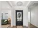 Bright foyer with a glass-paneled front door and wood floors, leading to a stylish interior at 19901 E Country Meadows Dr, Queen Creek, AZ 85142